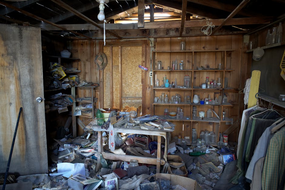 Home Interior view of an abandoned room filled with dusty and disorganized items, typical of urban decay.